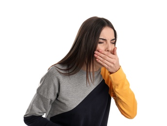 Beautiful young woman coughing against white background