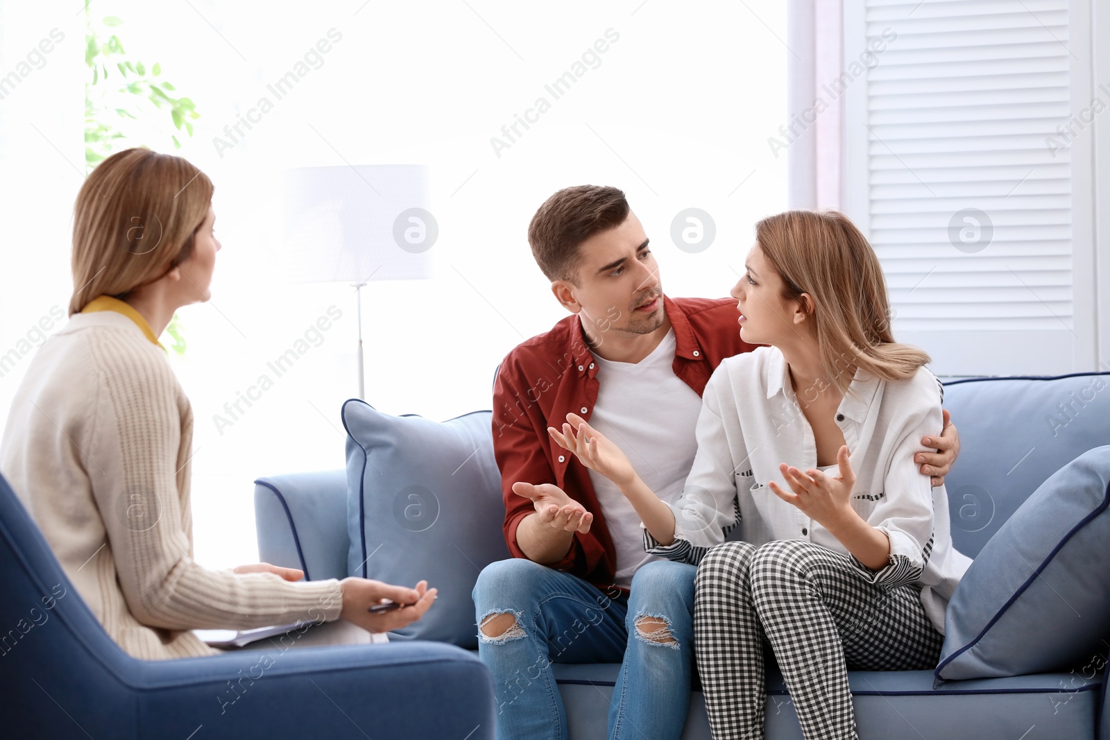 Photo of Young couple with problem at family psychologist office