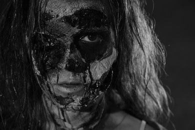 Scary zombie on dark background, black and white effect. Halloween monster