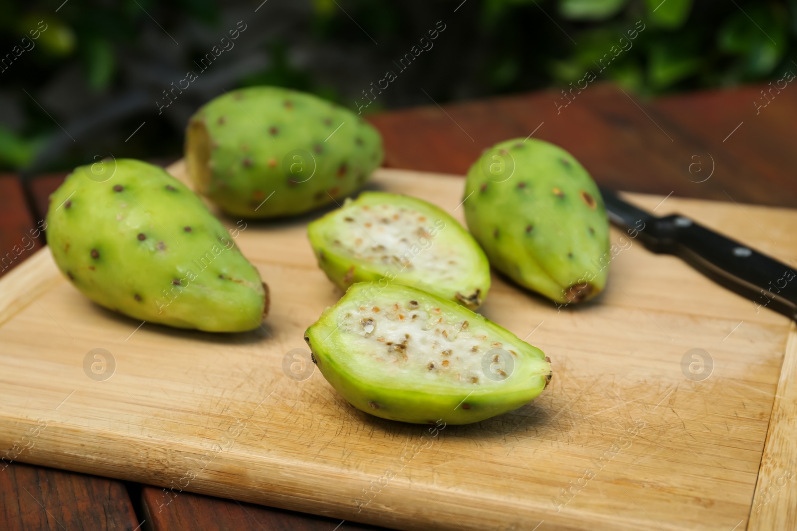 Photo of Tasty prickly pear fruits on wooden table, closeup