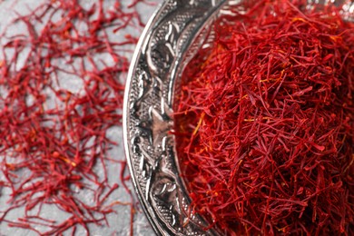 Dried saffron on grey table, flat lay