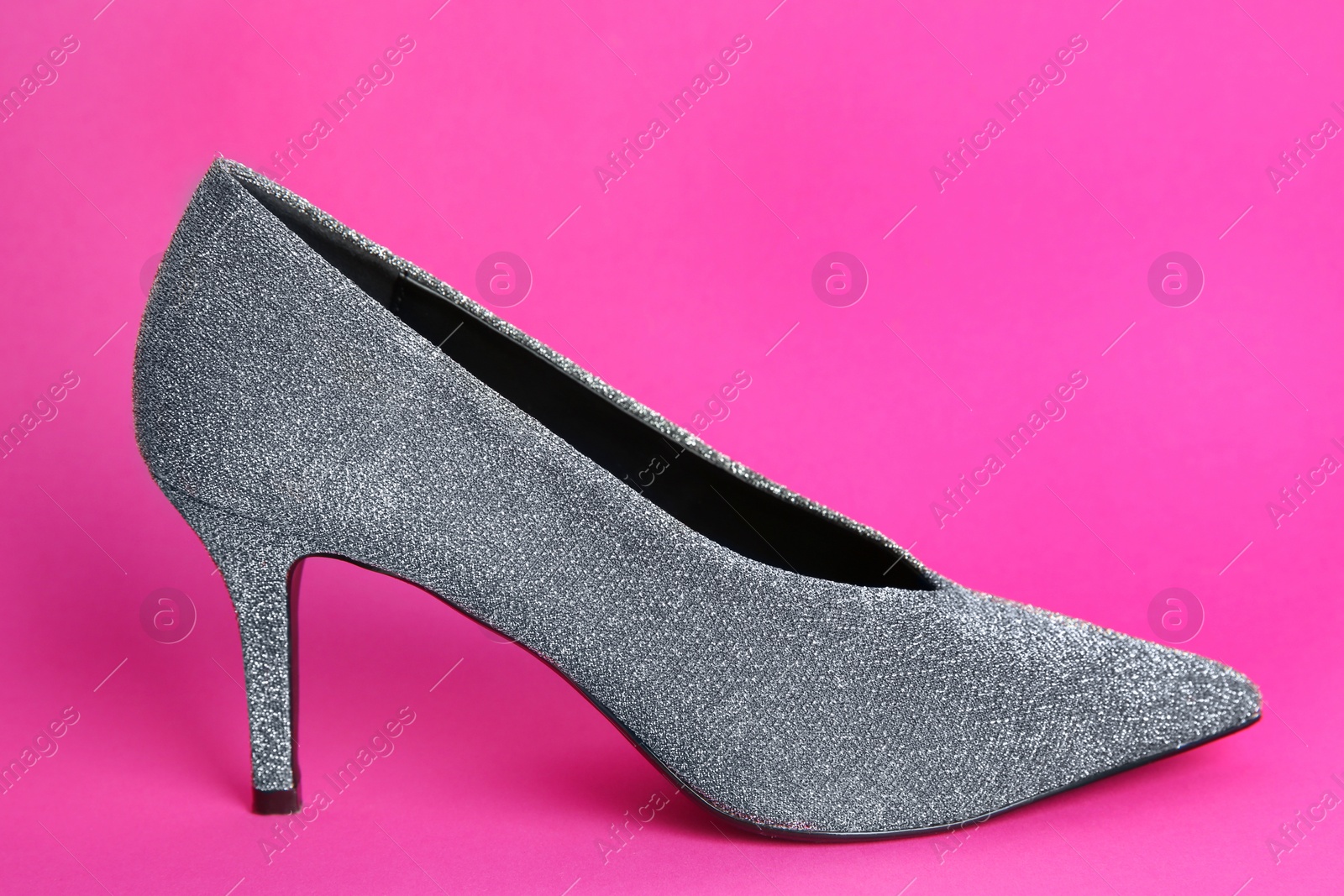 Photo of Female shoe on color background