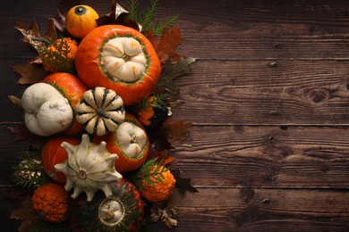 Photo of Flat lay composition with ripe pumpkins on wooden table. Space for text