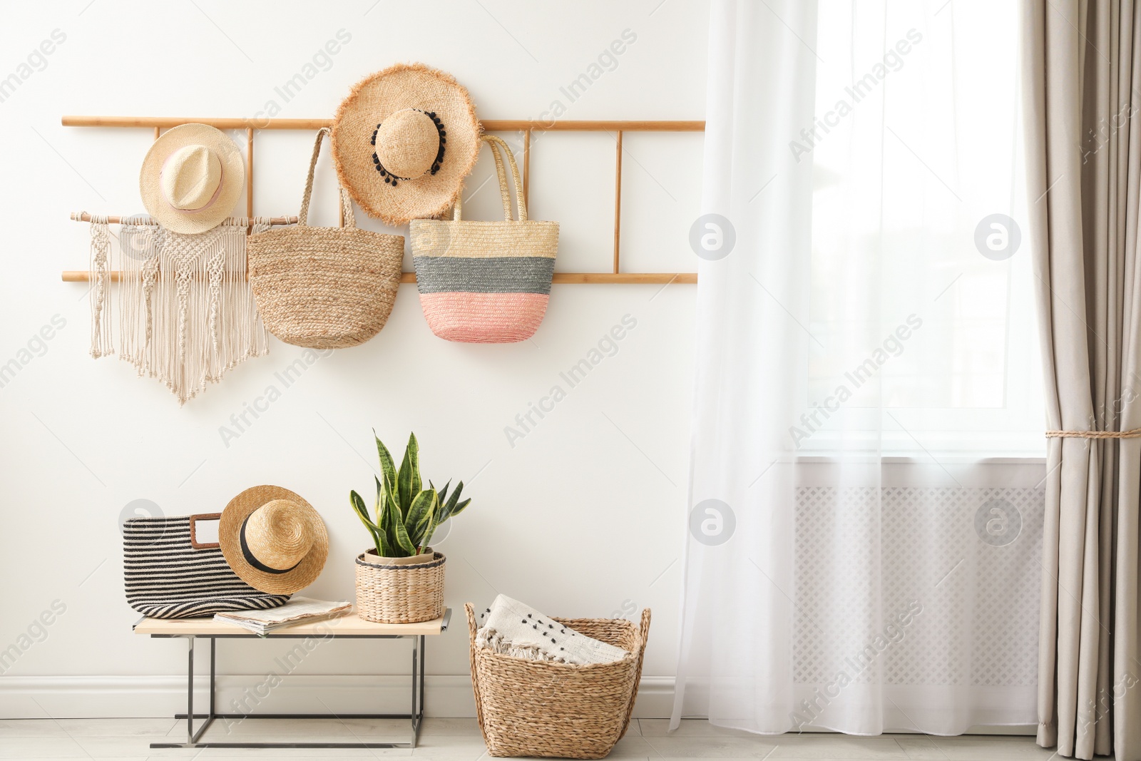 Photo of Decorative wooden ladder, bench and plant at home. Idea for interior design