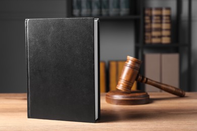 Photo of Law. Book and gavel on wooden table