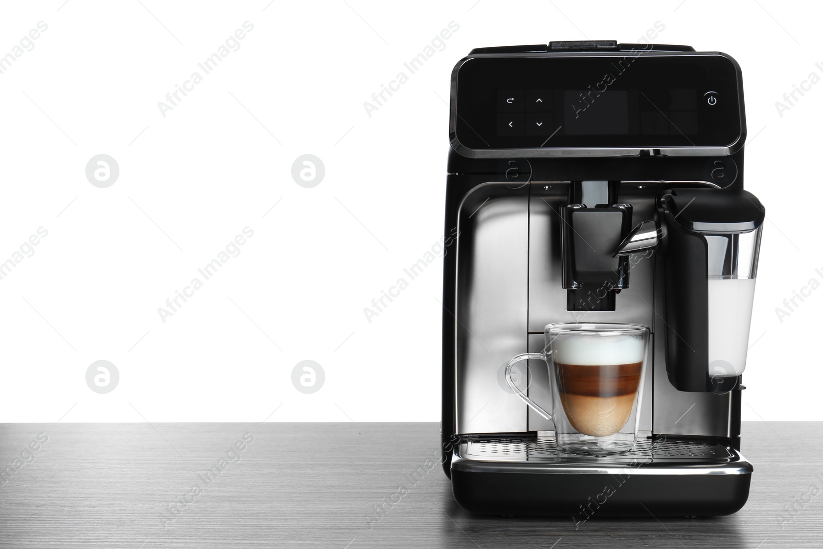 Photo of Modern coffee machine with glass cup of latte on wooden table against white background. Space for text