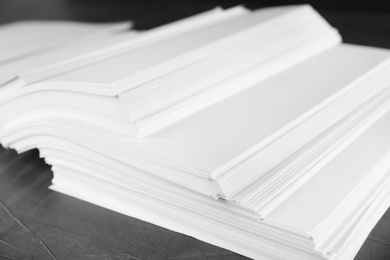 Photo of Stack of blank paper on grey stone table