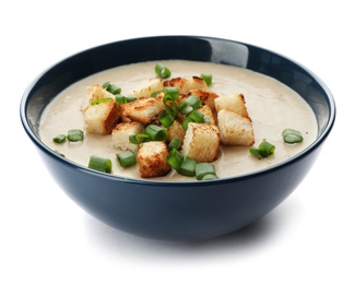 Bowl of fresh homemade mushroom soup on white background