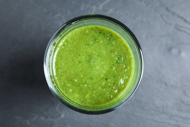 Photo of Delicious fresh green juice on black table, top view