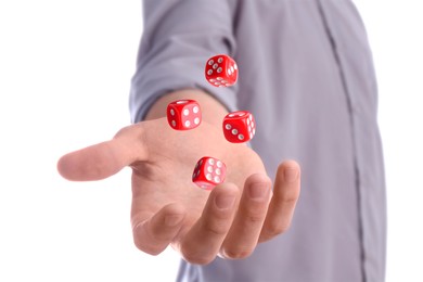 Man throwing red dice on white background, closeup