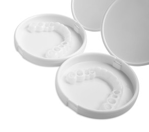 Containers with dental mouth guards on white background. Bite correction