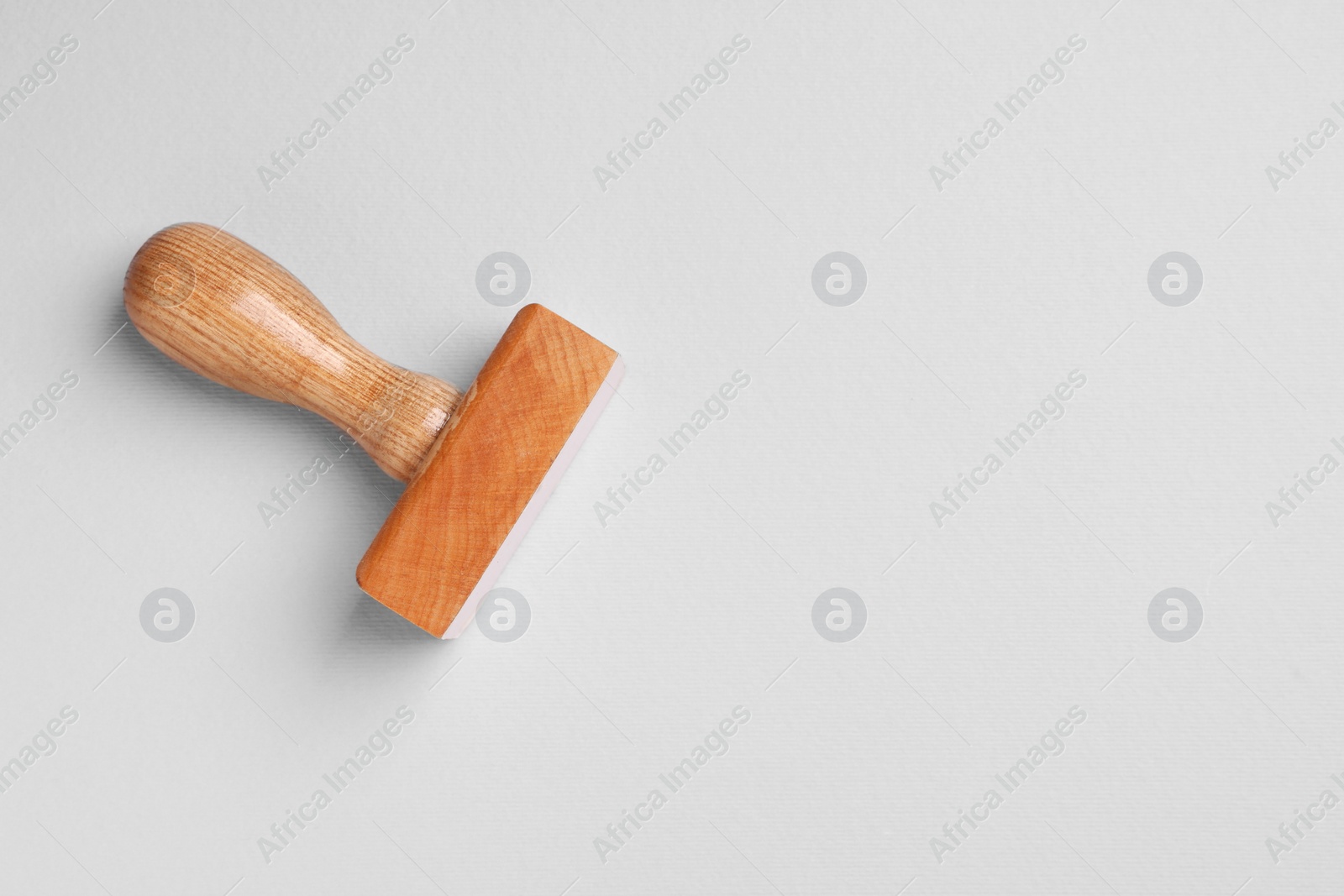 Photo of One wooden stamp tool on light grey background, top view. Space for text