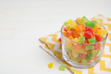 Photo of Mix of delicious candied fruits on white table. Space for text