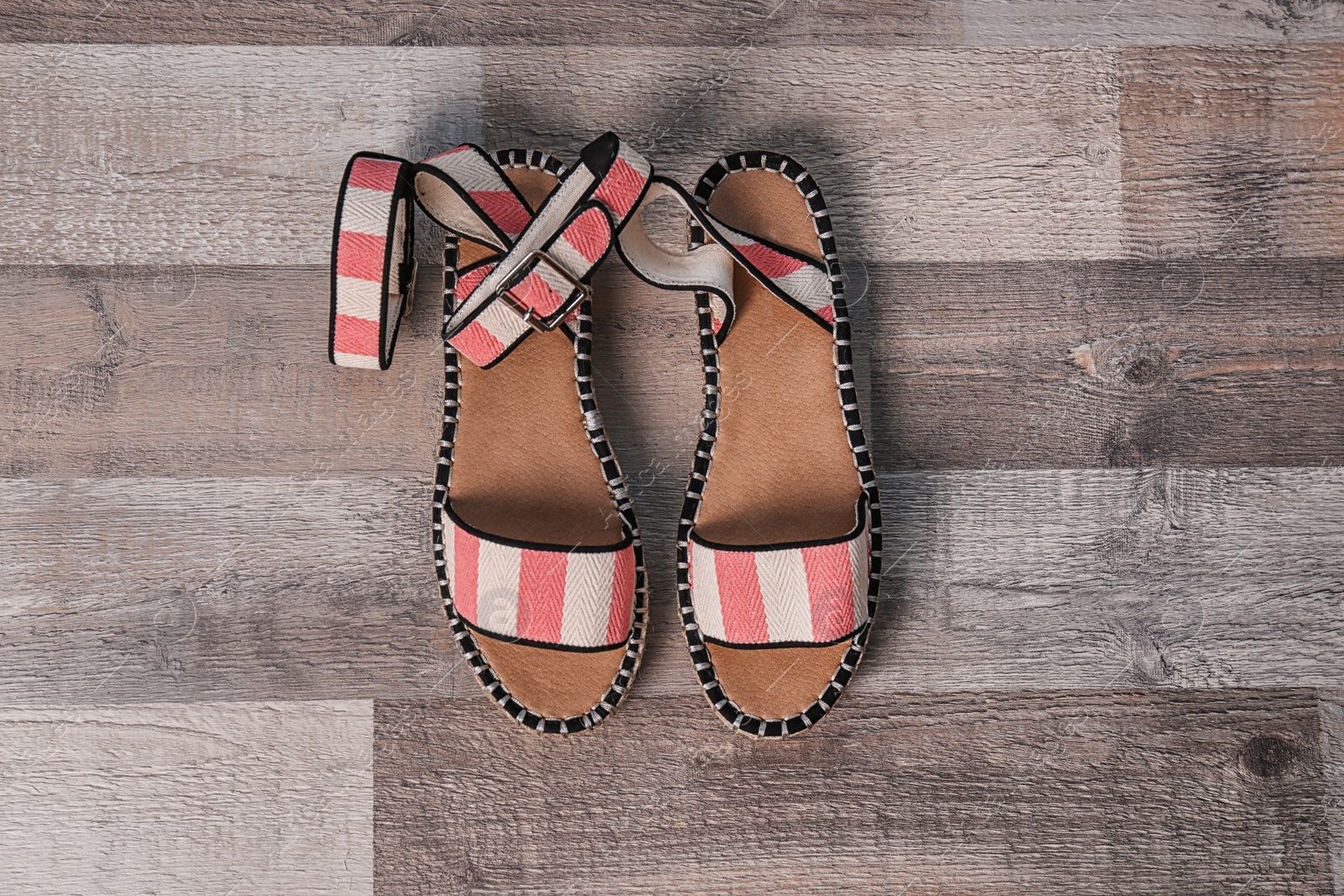 Photo of Pair of female shoes on wooden background, top view