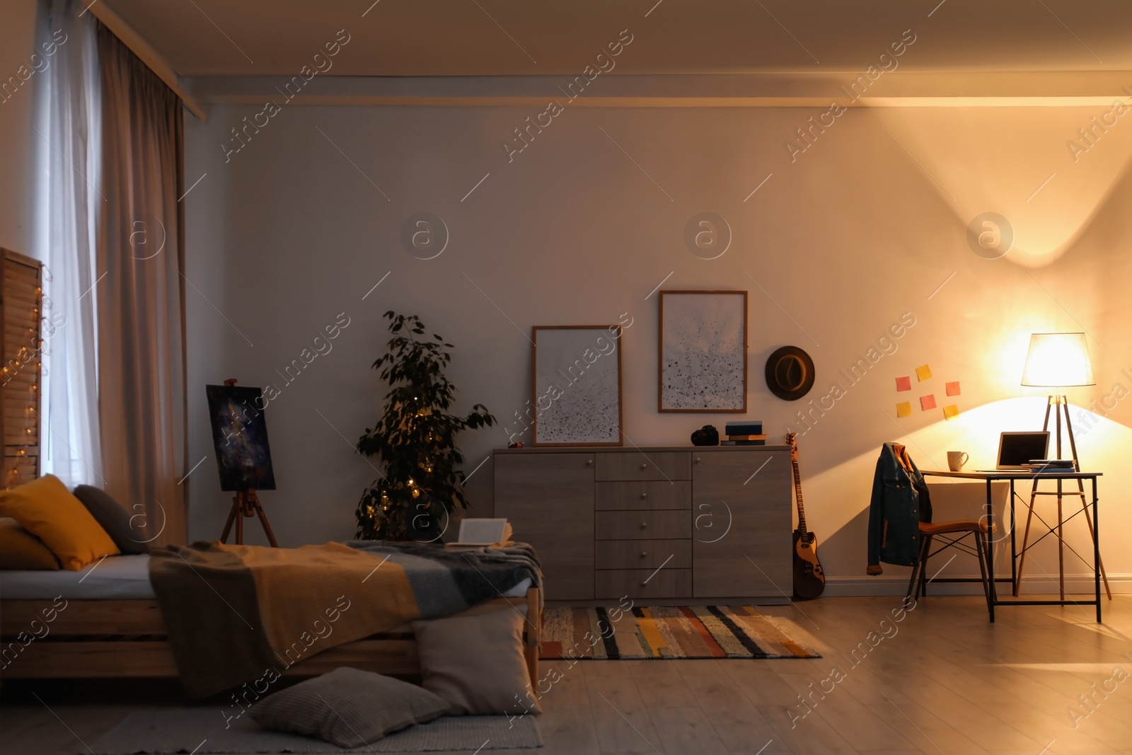 Photo of Stylish room interior with bed and workplace