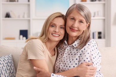 Happy mature mother and her daughter at home