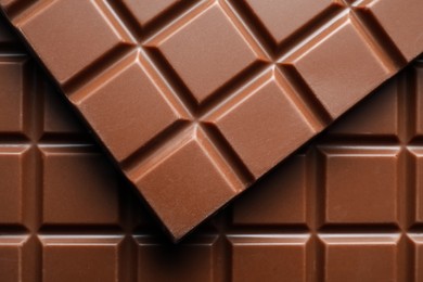 Photo of Delicious milk chocolate bars as background, top view