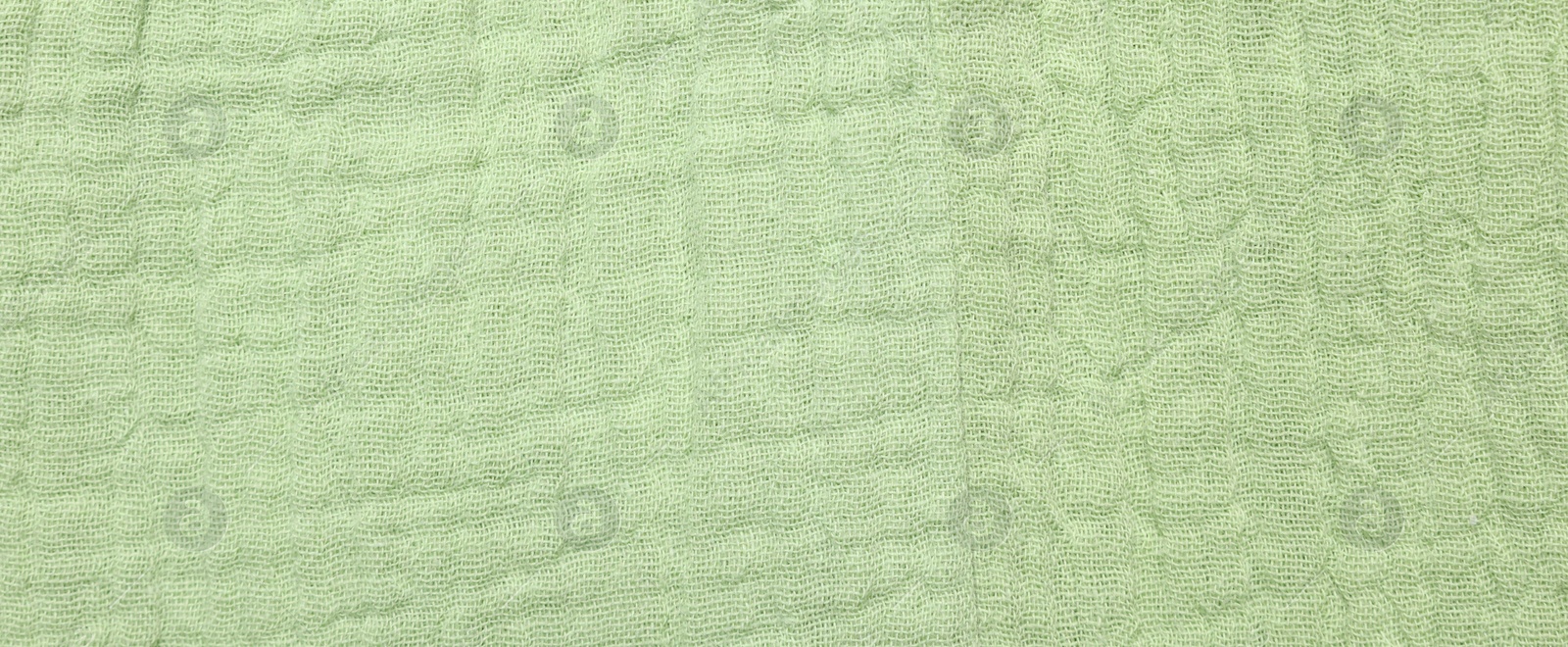 Photo of Texture of light green fabric as background, top view