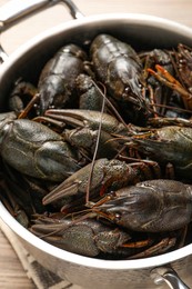 Photo of Fresh raw crayfishes in pot on table, above view