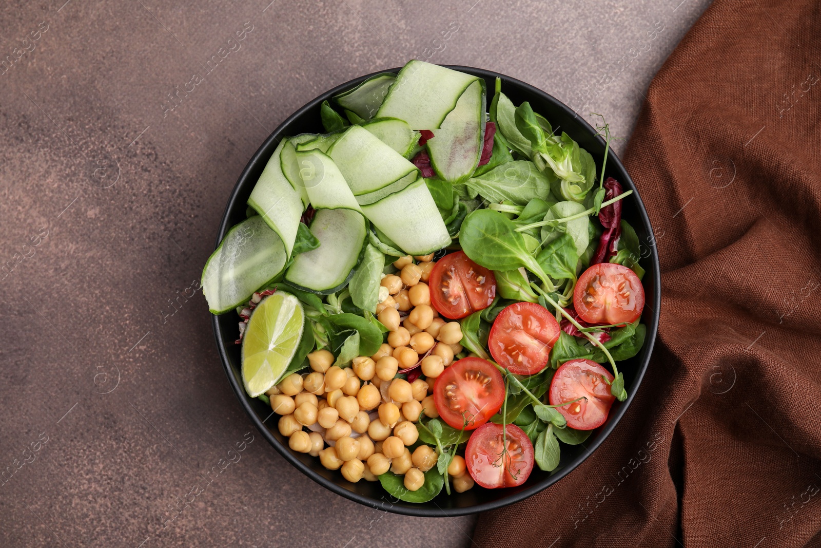 Photo of Tasty salad with chickpeas, cherry tomatoes and cucumbers on grey textured table, top view