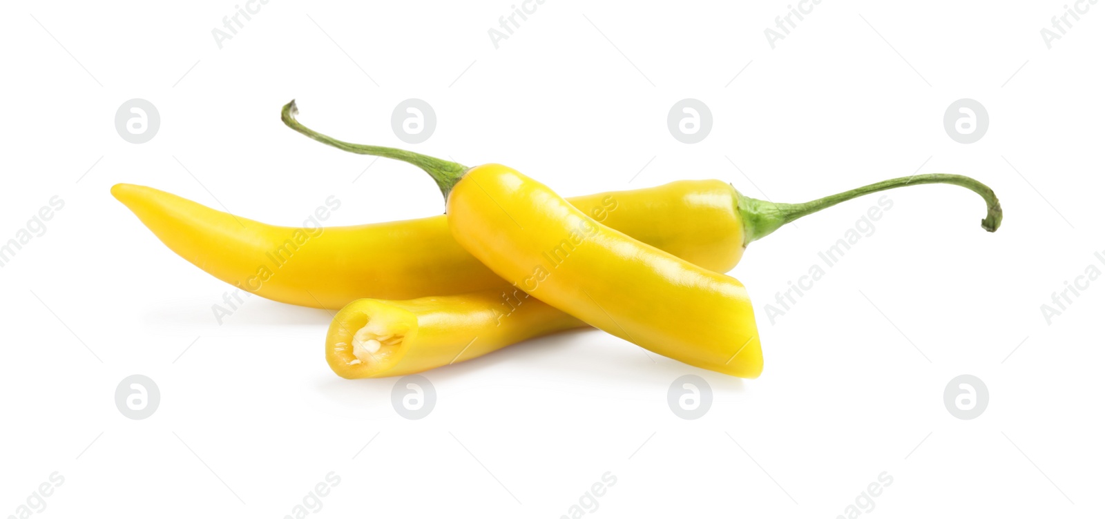 Photo of Cut and whole ripe yellow chili peppers isolated on white