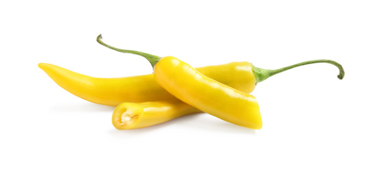 Photo of Cut and whole ripe yellow chili peppers isolated on white