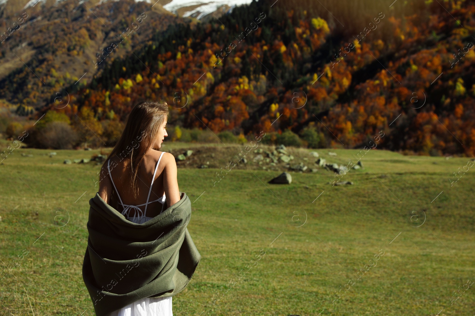 Photo of Young woman walking in beautiful mountains on sunny day. Space for text