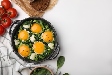 Flat lay composition with tasty green Shakshouka and ingredients on white table. Space for text