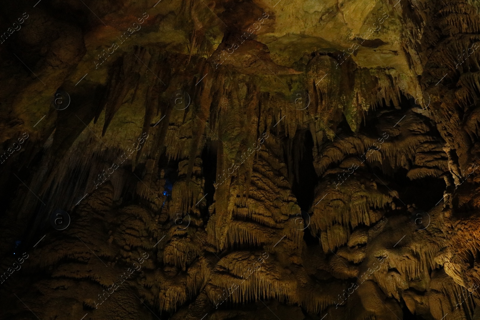 Photo of Picturesque view of many stalactite formations in cave