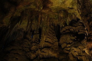 Photo of Picturesque view of many stalactite formations in cave