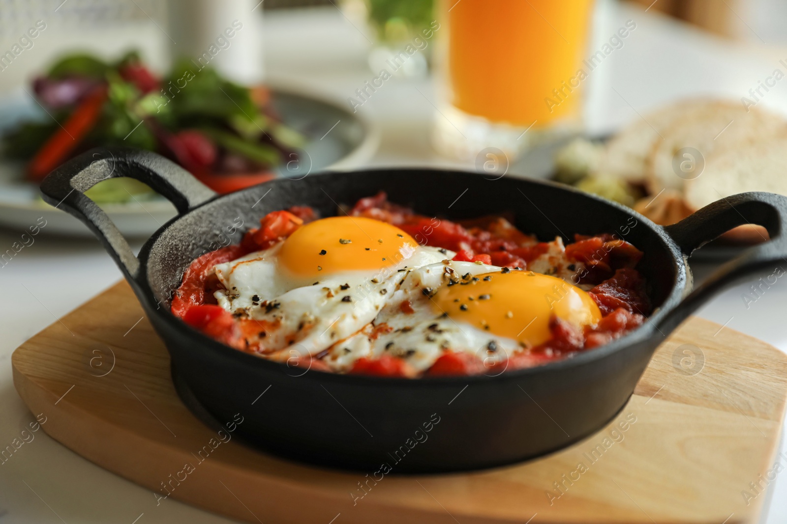 Photo of Tasty Shakshouka served on white table, closeup. Traditional Arabic dish