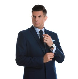 Photo of Handsome stylish man putting on cufflink against white background