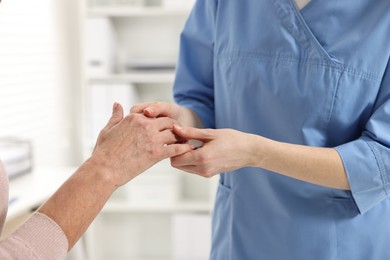 Photo of Arthritis symptoms. Doctor examining patient's hand in hospital, closeup