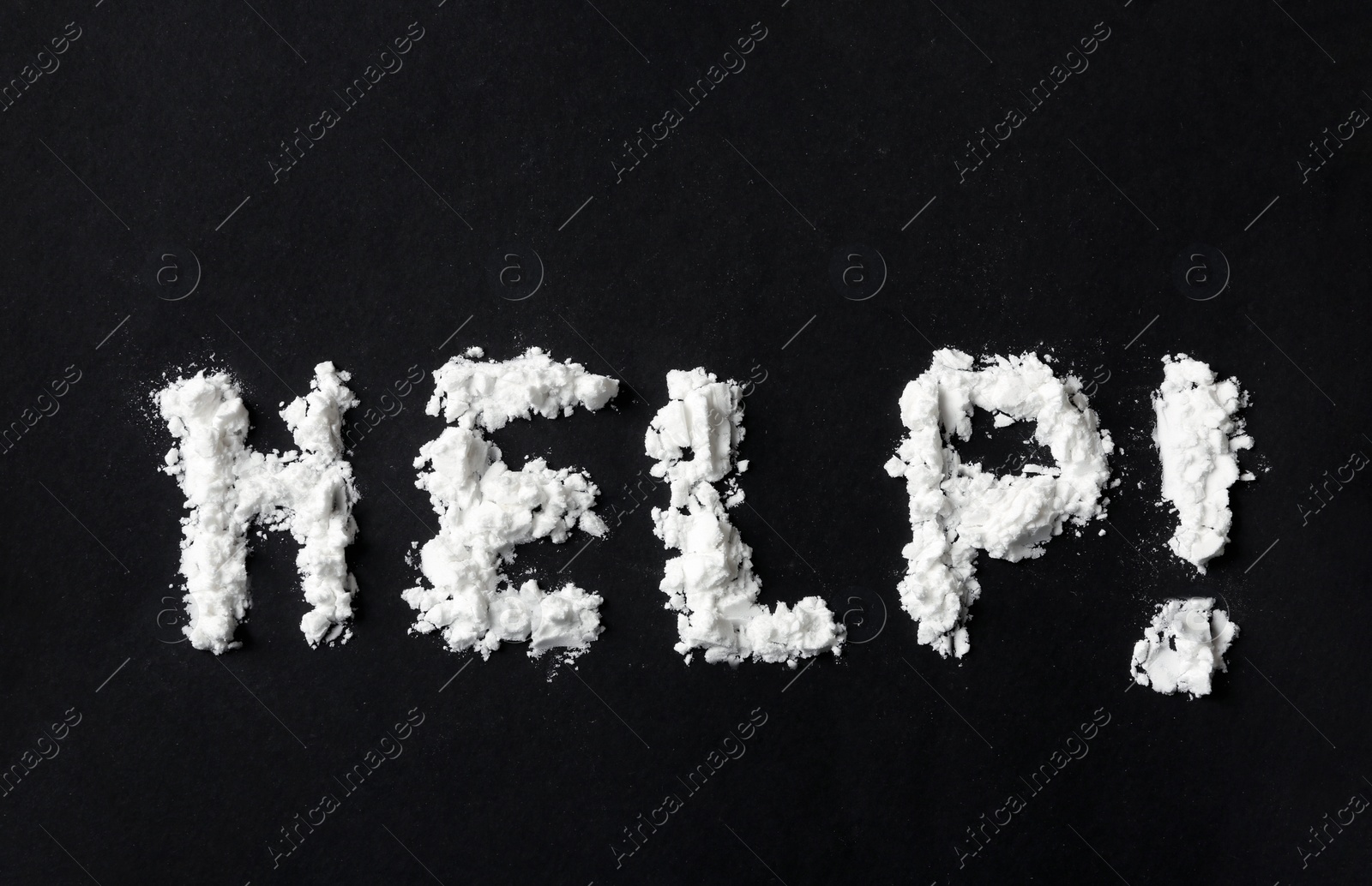 Photo of Text Help written with cocaine powder on black background, top view