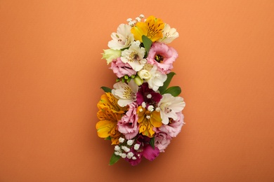 Photo of Number 8 made of beautiful flowers on orange background, flat lay. International Women's day