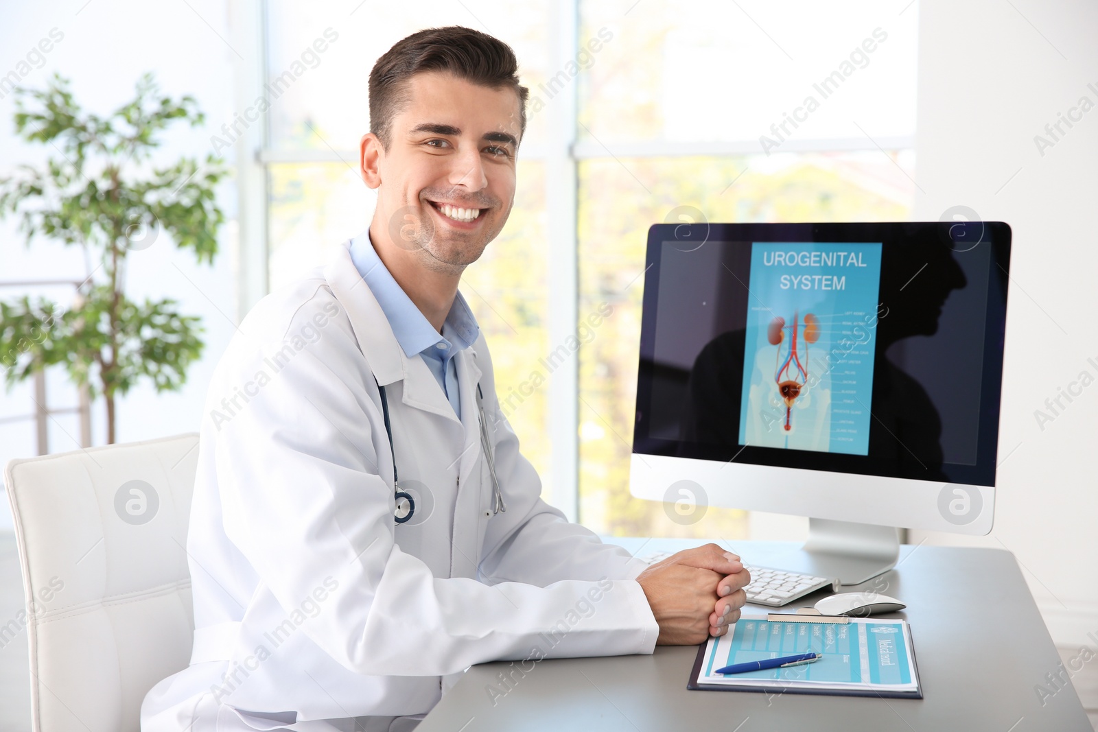 Photo of Portrait of young urologist at table in hospital