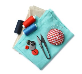 Scissors, spools of threads and sewing tools on white background, top view