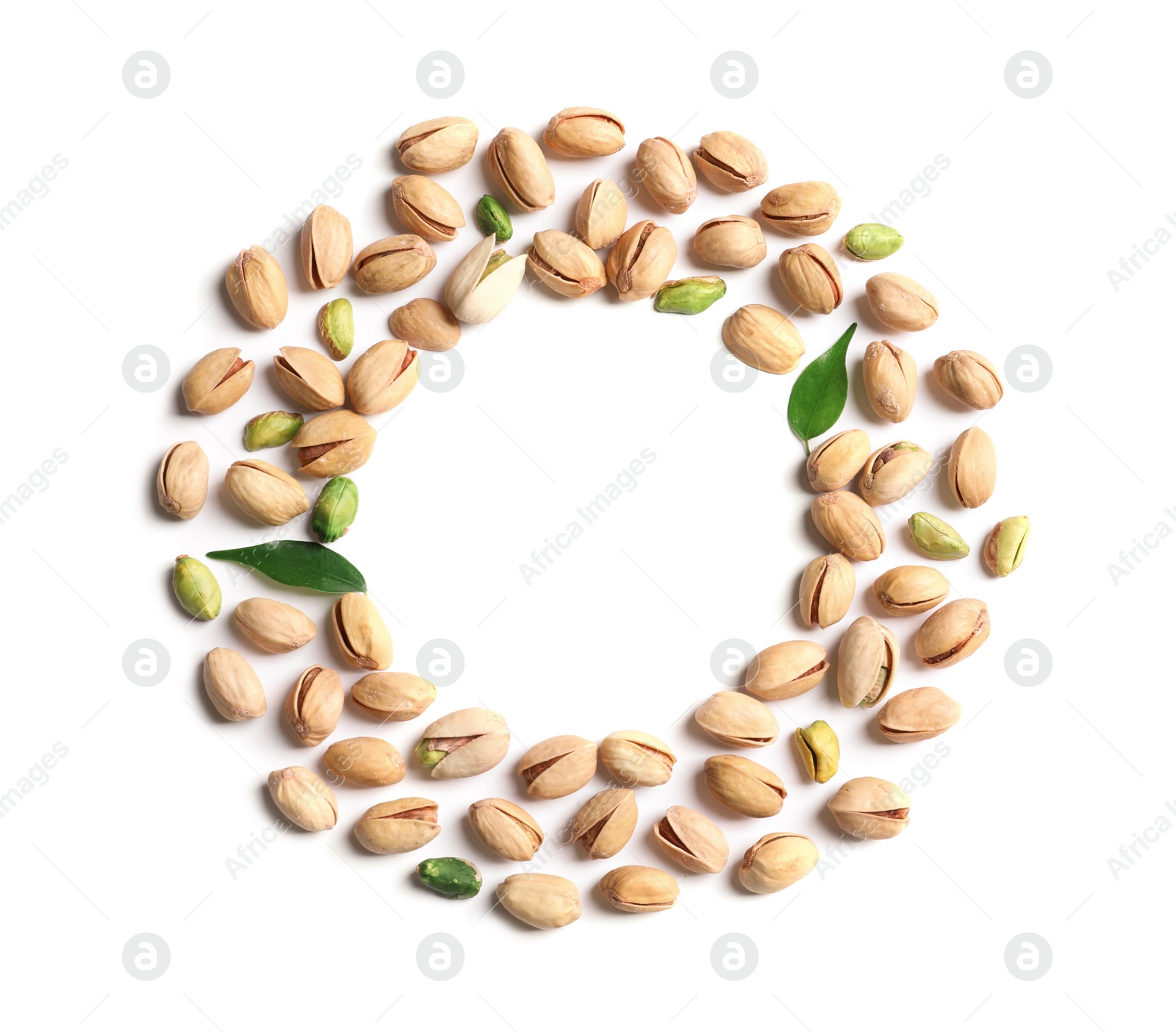 Photo of Frame made of organic pistachio nuts on white background, flat lay. Space for text