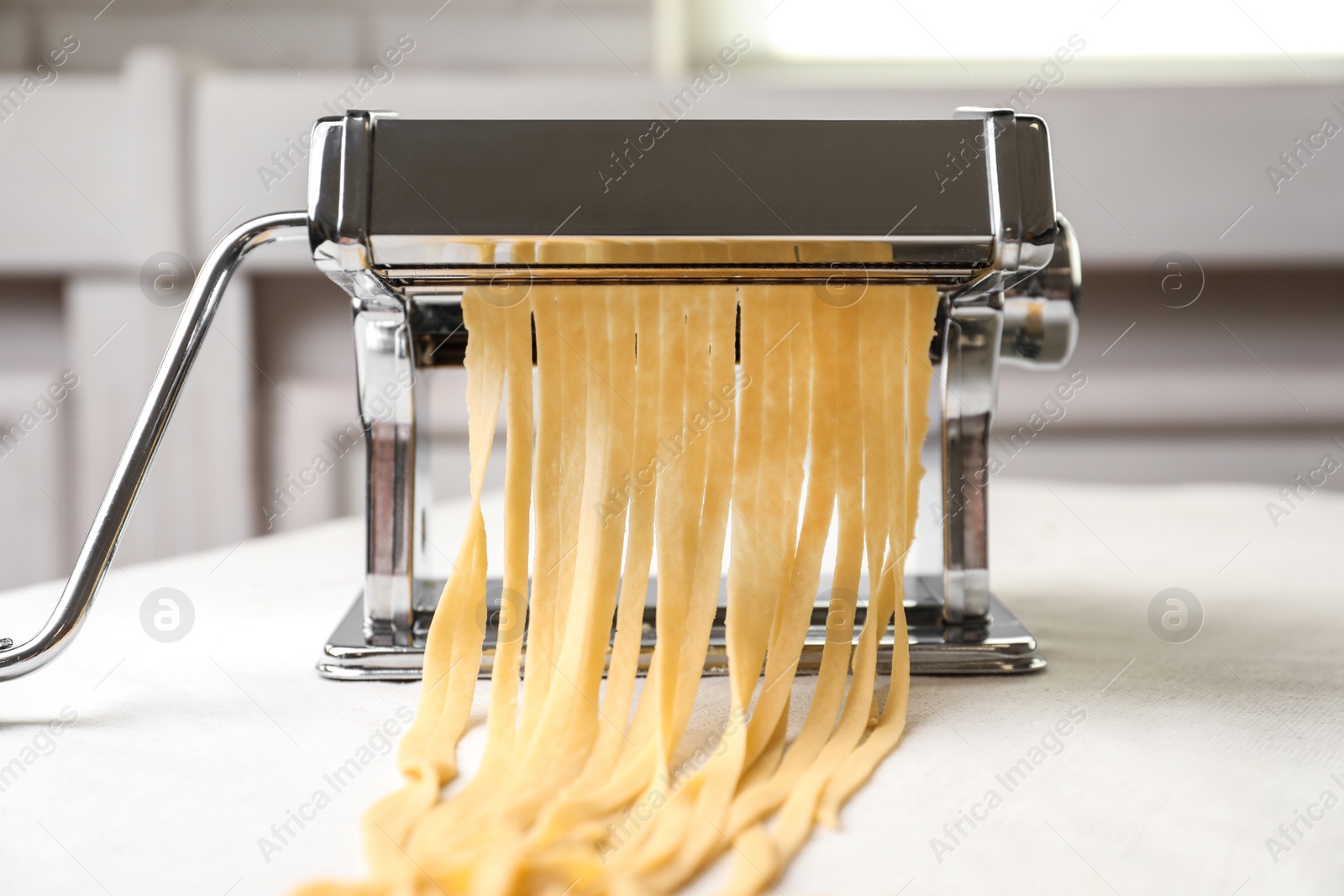 Photo of Pasta maker with wheat dough on table