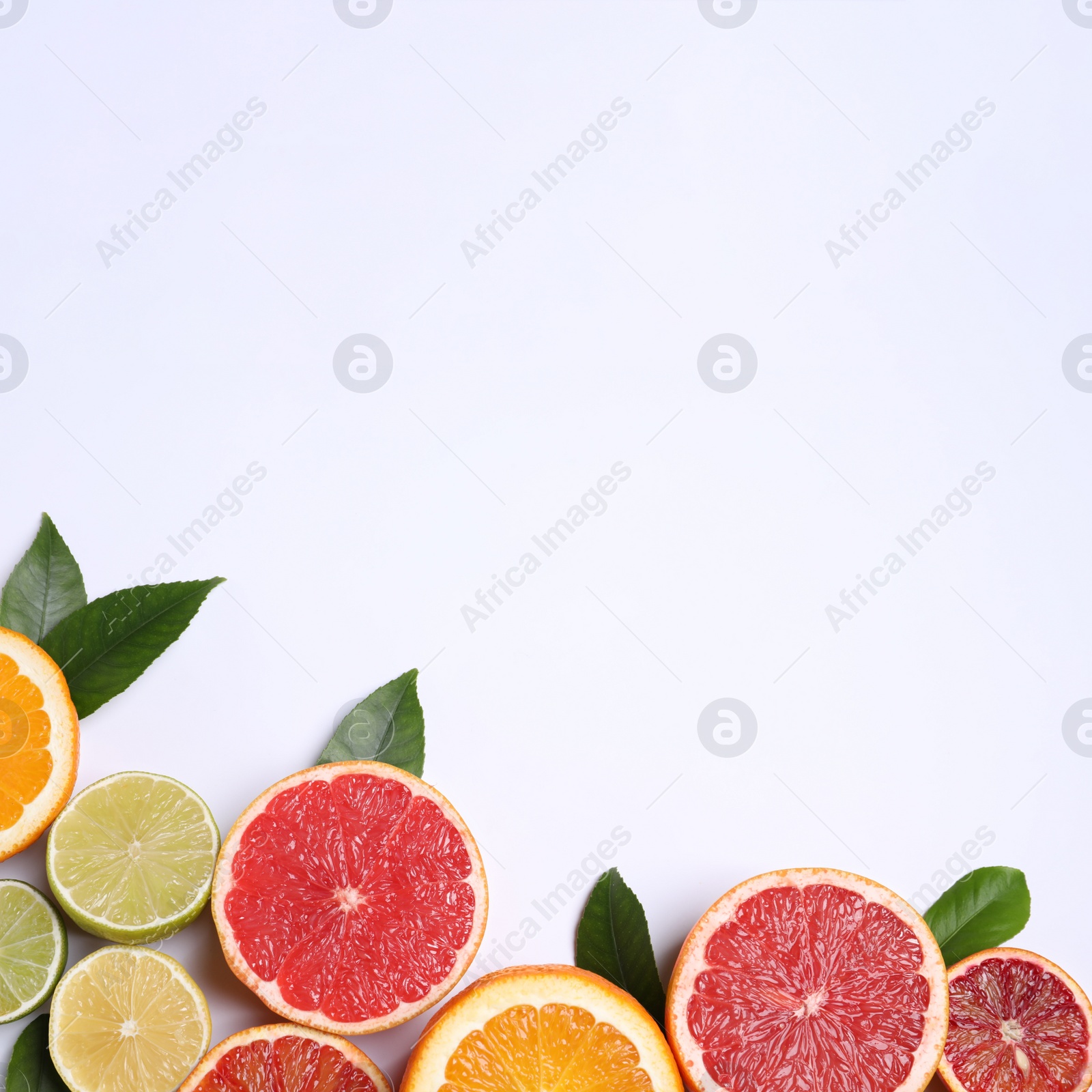 Photo of Fresh juicy citrus fruits with green leaves on white background, flat lay. Space for text