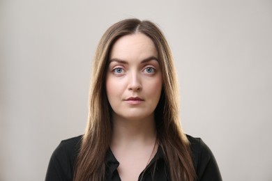 Photo of Portrait of beautiful young woman on beige background