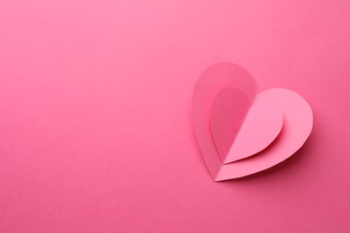 Paper hearts on pink background, top view. Space for text