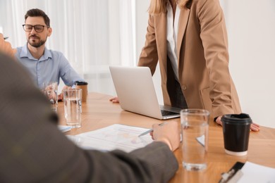 Photo of Businesswoman having meeting with her employees in office, closeup