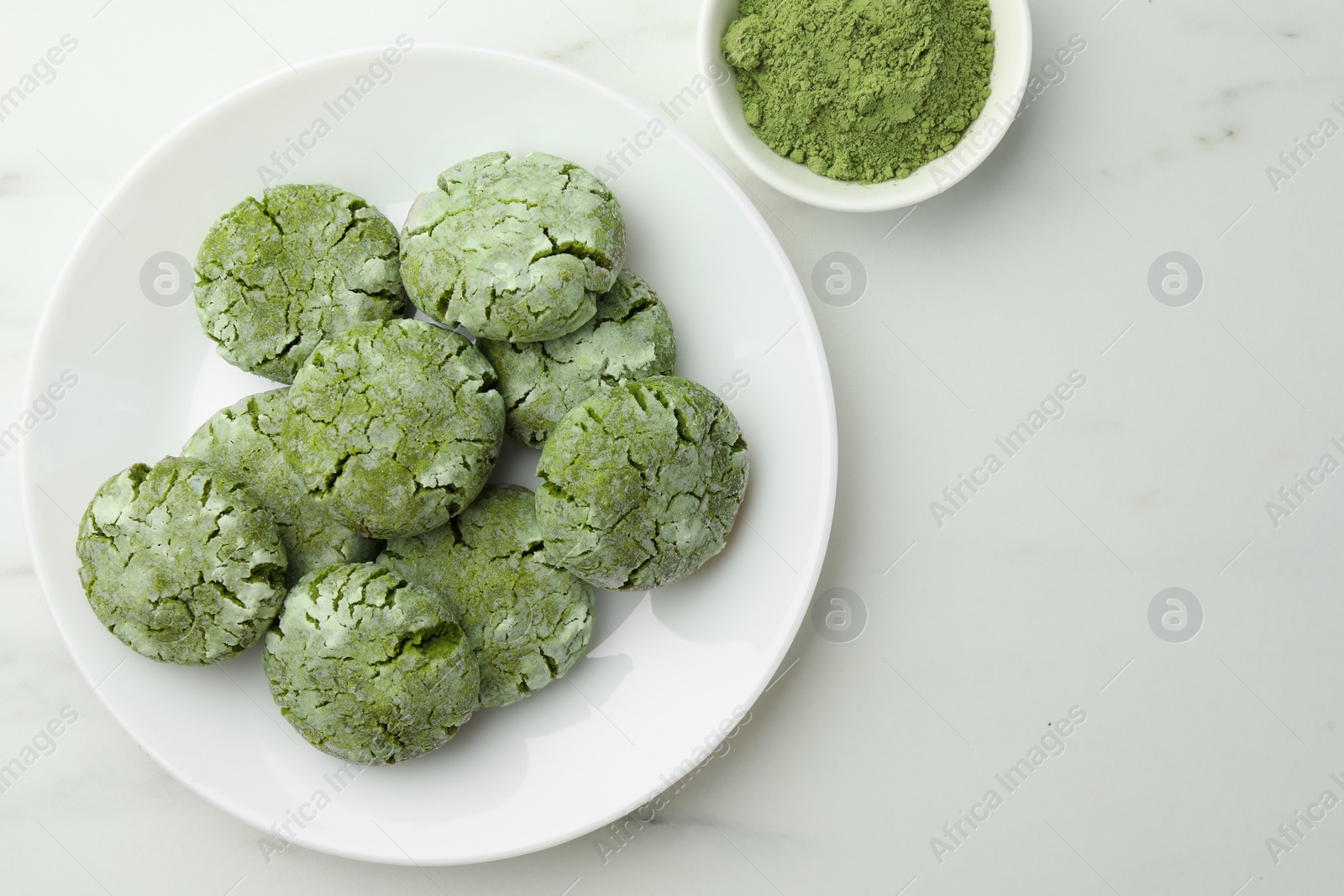Photo of Plate with tasty matcha cookies and powder on white table, flat lay. Space for text