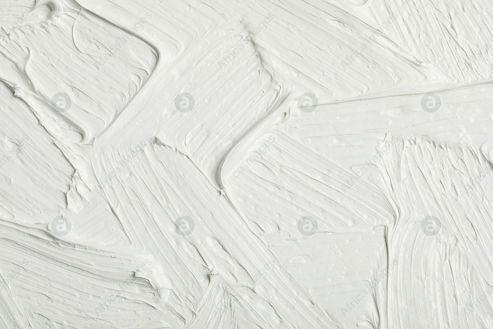 Photo of Texture of white oil paint as background, closeup