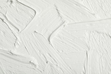 Photo of Texture of white oil paint as background, closeup