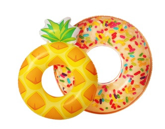 Different bright inflatable rings on white background. Summer holidays