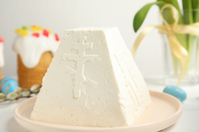 Photo of Traditional cottage cheese Easter paskha on white table, closeup