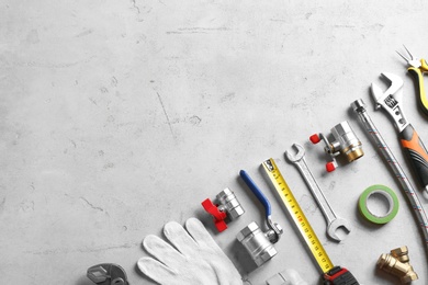 Photo of Flat lay composition with plumber's tools and space for text on grunge background