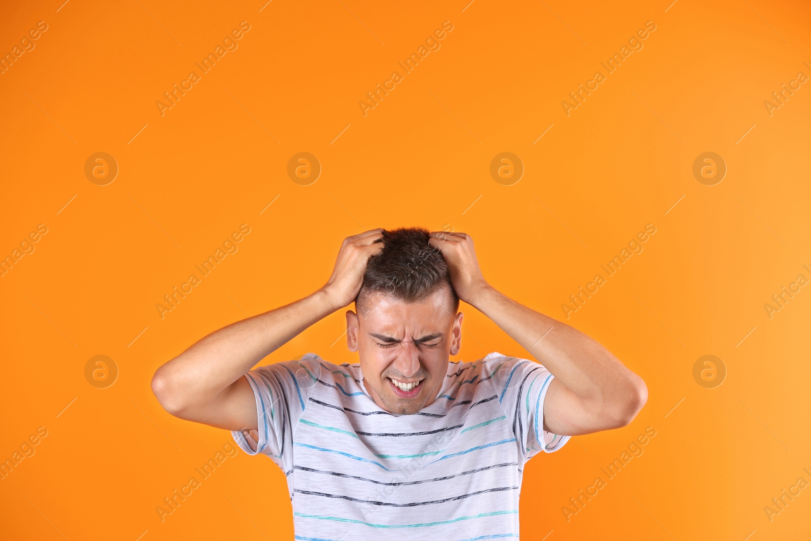 Photo of Handsome emotional young man on color background